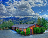 Perched on a mountain plateau at 4000 feet elevation is a very private, custom home on a large, level, usable pad.